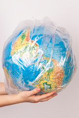 they hold a globe in their hands. a globe is a model of the earth. world map