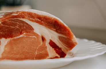 Raw meat on a white plate