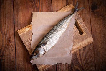 Hot smoked mackerel on the table in the kitchen. Studio photo. - obrazy, fototapety, plakaty