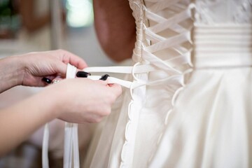 tying corset bride closeup