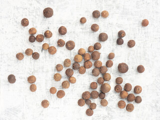 Bunch of spice Allspice (Jamaica pepper, Pimento) on white concrete background. Macro. Flat lay. Healthy eating concept
