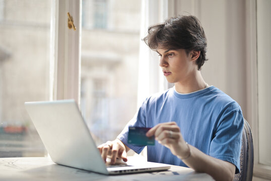 portrait of young man while doing online shopping
