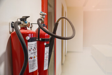 Fire extinguisher and gas pump system on the wall. Powerful emergency fire extinguisher equipment....