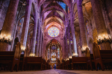 Low angle horizontal photograph of the altar and rose window taken from the main door at the inside...