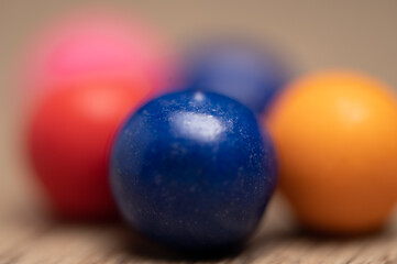 Close up of multicolored gum balls, chewing gum pink blue and white in antique gum ball machine