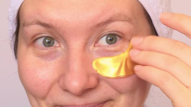 Eye patch procedure. Facial hydrogel treatment. Dermatology spa mask. Detox therapy. Rejuvenation skincare beauty. Cosmetics gold product. Light background. Self care home routine. Happy face