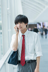 Fototapeta premium 通学中に電話をする男子高校生