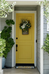 traditional Cape Cod cottage with bright yellow front door