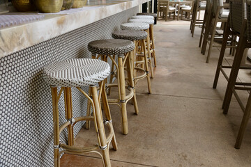 bistro bar stool made of bamboo against mosaic tiled wall