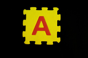 Colorful alphabet puzzle isolated on black background. alphabet learning block for children education.
