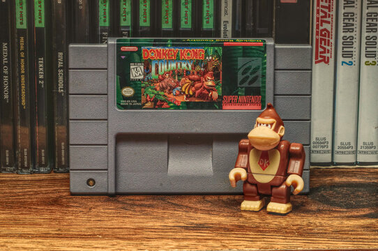 Donkey Kong toy beside a DKC cartridge, with a paint effect on the photo (NC State, 2022)