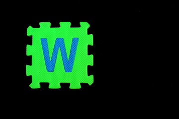 Colorful alphabet puzzle isolated on black background. alphabet learning block for children education.
