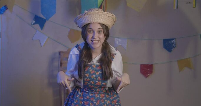 Girl wearing typical clothes for Festa Junina. symbol of here, come here. For the Arraia party