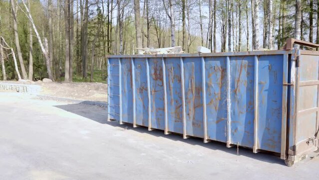 container with construction waste for transportation by road