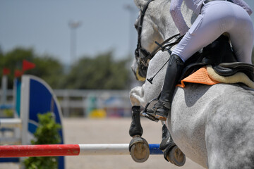 The rider on horseback overcomes the obstacle during the equestrian event