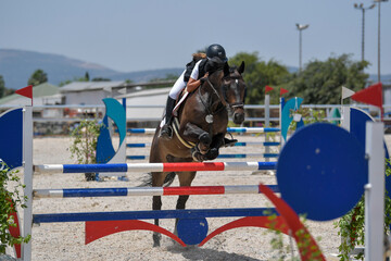 The rider on horseback overcomes the obstacle during the equestrian event