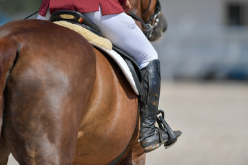 Obraz premium The rider on horseback overcomes the obstacle during the equestrian event