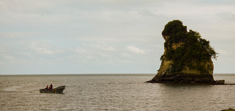 Hill in the sea with a boat