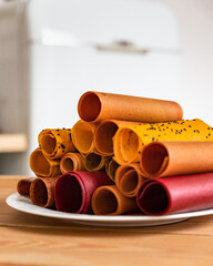 Assorted of fruit and berry marshmallow on ceramic dish. Pastille fruit rolls. Healthy raw sweets. Diet vitamin food and vegan food.