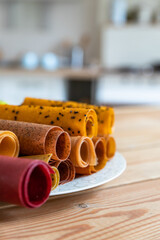 Assorted of fruit and berry marshmallow on ceramic dish. Pastille fruit rolls. Healthy raw sweets. Diet vitamin food and vegan food.