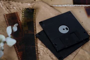 Vintage old-fashioned ways to keep memories. VHS, disk and cd's on a retro background.