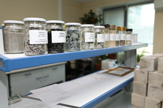 Modern laboratory for testing road samples and materials concept. Samples of bulk inert materials on laboratory shelves.