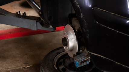 New car brake disc on old car, garage car service