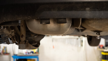 Car Exhaust system, view from on the bridge at a auto repair service. Car underneath.