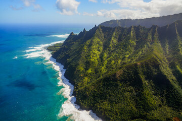 Aerial view of the dramatic ridges of the Na Pali coast, looming over the Pacific Ocean on the northwestern side of Kauai island in Hawaii