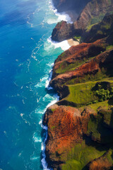 Aerial view of the dramatic ridges of the Na Pali coast, looming over the Pacific Ocean on the northwestern side of Kauai island in Hawaii