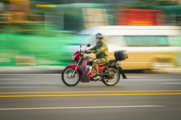 Panning shot of moving motorcycle, motion picture