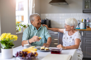 Senior couple having breakfast and talking
