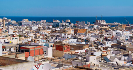 Fototapeta premium View of Tunisian cityscape of houses near to port of Sousse. Many satellite dish, antennas on private houses.