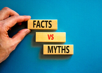 Facts vs myths symbol. Concept words Facts vs myths on wooden blocks on a beautiful blue table blue...