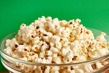 Large transparent bowl filled with popcorn.