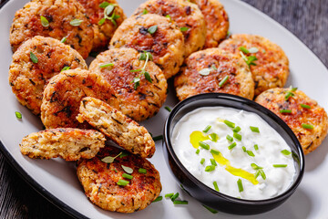 cauliflower patties on plate with yogurt sauce
