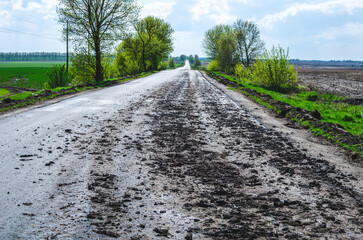 Dirty asphalt due to agricultural machinery that carries manure to the field