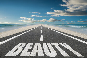 The word beauty written on a highway in nature.