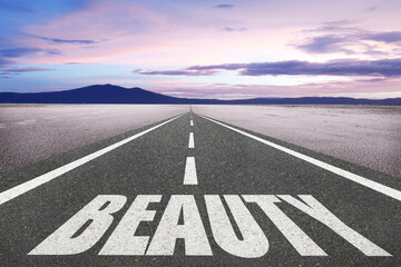 The word beauty written on a highway in nature.