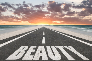 The word beauty written on a highway in nature.