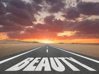 The word beauty written on a highway in nature.