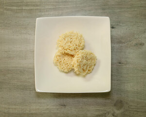 Top view of no-bake coconut cookies. Shredded coconut fat bombs.
