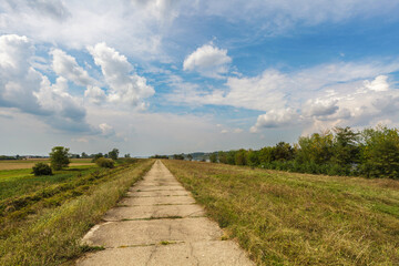 Old concrete way under blue cloudy sky