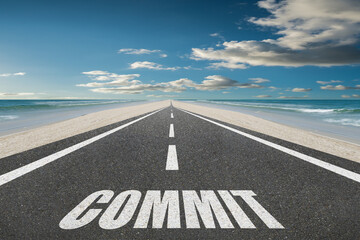 The word Commit written on a highway for commitment and dedication concept.