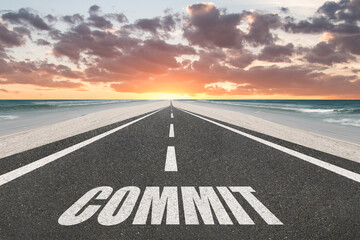 The word Commit written on a highway for commitment and dedication concept.