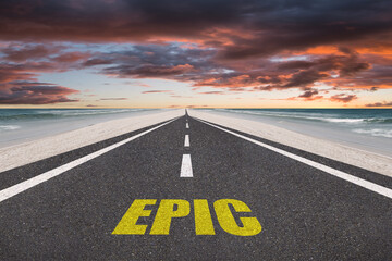 The word Epic on a highway leading into the sunset at the beach.