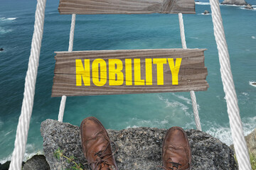 Nobility written on a dangerous rope bridge above the ocean.