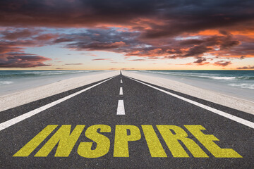 Inspire text on a highway leading to success for inspirational concept.