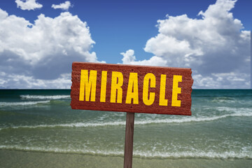 Beautiful beach with Miracle sign and the elements of nature.