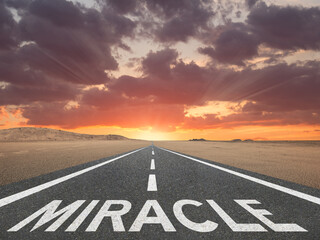 The word Miracle on a road leading to a beautiful sky at the horizon.